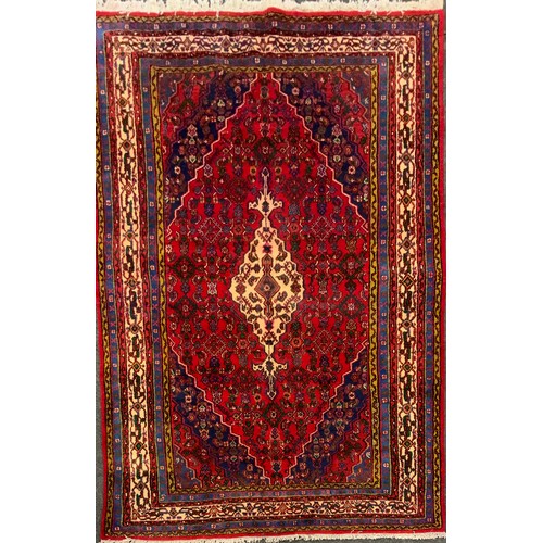 125 - A North West Persian Hamadan Carpet, multi-tones of cream, blue, green and yellow, red filed, 302cm ... 