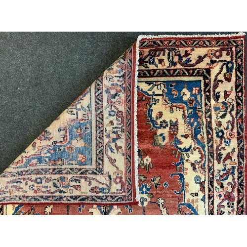 139 - A North West Persian Mahal Rug, in tones or cream, blue, red and yellow, 245cm x 140cm