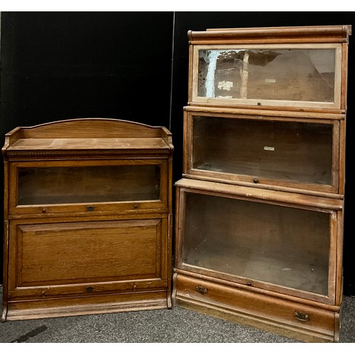 150 - A Globe Wernicke Co. Ltd., oak three tier, stepped bookcase, each tier with a sliding up-and-over gl... 