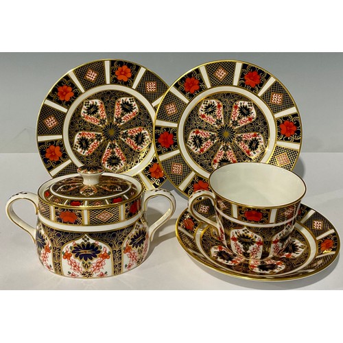 76 - A Royal Crown Derby 1128 Imari pattern sucrier and cover, first quality; a 1128 pattern cup and sauc... 