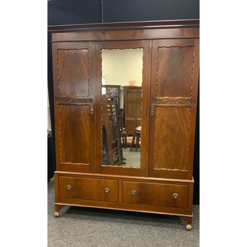 167 - An early 20th century mahogany bedroom suite, comprising triple wardrobe, tall boy, dressing chest, ... 