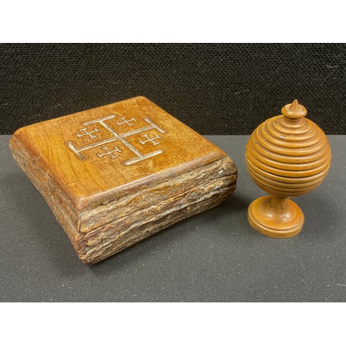 216 - Treen - An ecclesiastical box with cross symbols to cover, a turned wood rotating game