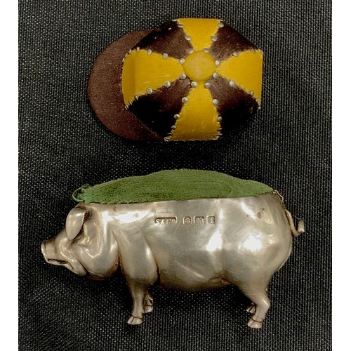 249 - A silver pin cushion as a pig, Birmingham,1905, 7cm long; jockey cap pin cushion (2)