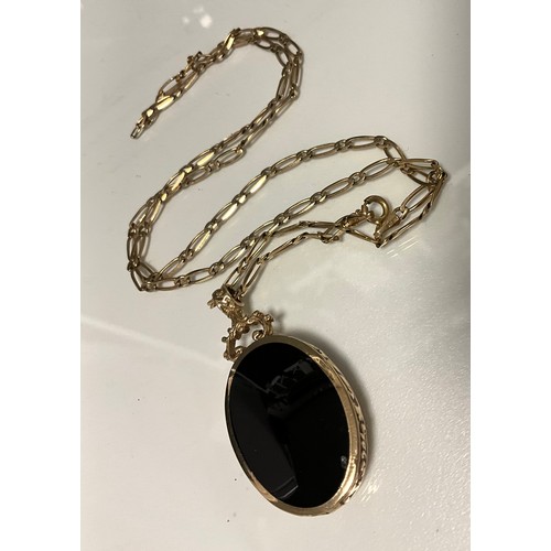 291 - A tigers aye and black onyx reversible pendant necklace, 9ct gold mount and fancy link chain, 58cm l... 