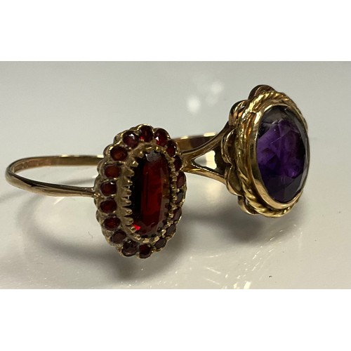 300 - Rings - a 9ct gold garnet cluster ring, size V, 2.7g gross;  amethyst glass 9ct gold dress ring, Siz... 