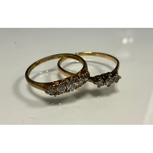 311 - A diamond ring, set with three round brilliant cut diamonds, 18ct gold shank, size W, 2g gross;  9ct... 