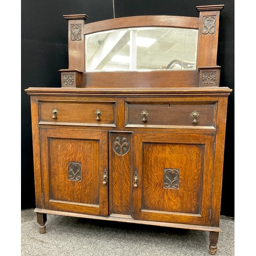 205 - A carved oak Art Nouveau mirror-back side cabinet, two drawers to frieze, one with draw-out writing ... 