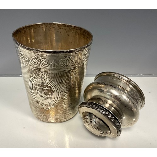 316 - A Continental silver beaker, vacant cartouche within textured scaled ground, beneath floral collar, ... 