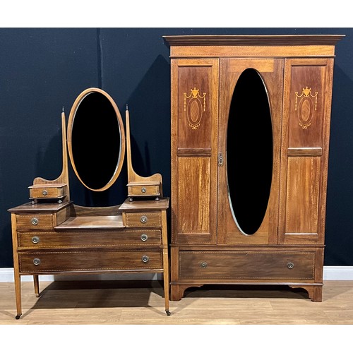 603 - An Edwardian two-piece bedroom suite, comprising wardrobe and dressing table, the wardrobe 200cm hig... 