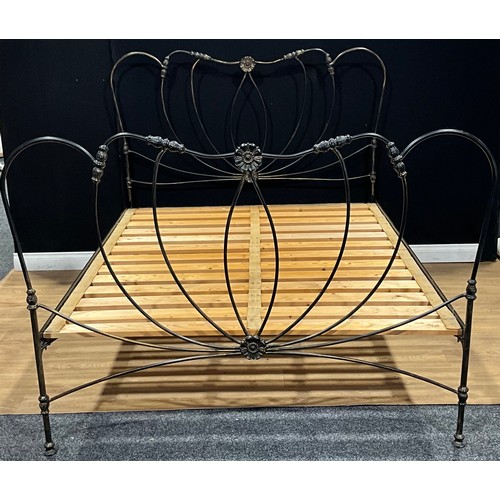 627 - A contemporary 19th century style cast metal bed, the headboard 140cm high, 168m wide