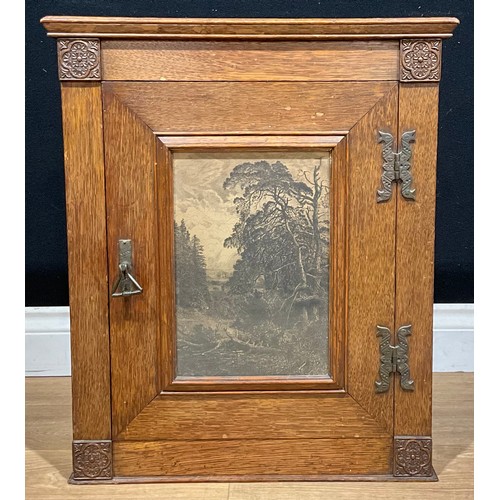 641 - An Arts & Crafts oak wall cabinet, the door set with a glazed lithographic landscape print and enclo... 