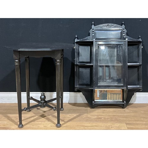 653 - A late Victorian/Edwardian ebonised wall cabinet, 92cm high, 70.5cm wide; an ebonised centre table, ... 