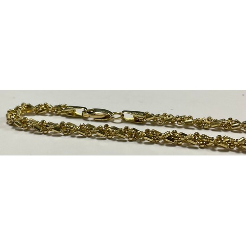 571 - A 14k gold Midas necklace, marked, 13.4g