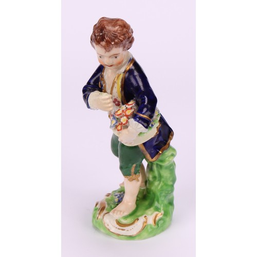 669 - A matched pair of Derby figures, Boy and Girl with Fruit and Flowers, he stands holding a basket of ... 