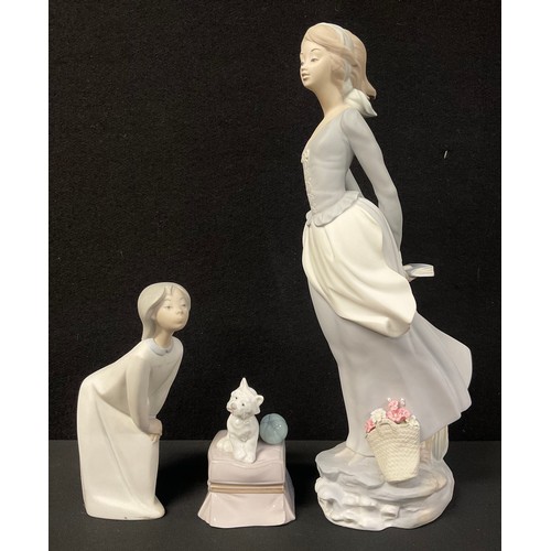 672 - A Lladro figure of a lady with basket of flowers at her feet, 36cm; a Lladro figure of a girl, 18cm;... 