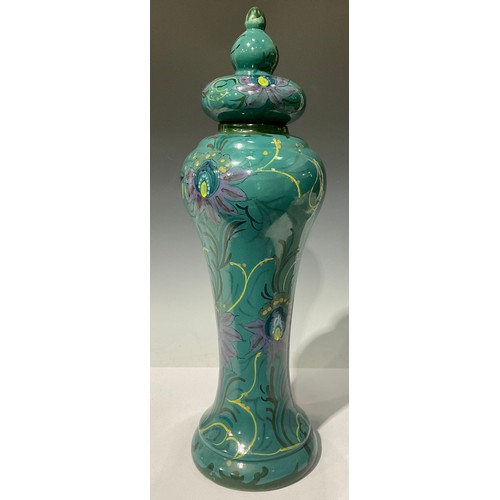 678 - A large Gouda Art Nouveau waisted vase and cover, decorated in polychrome with stylised flowers on a... 