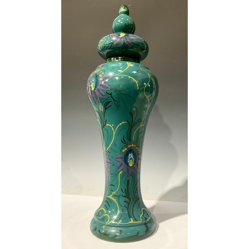 678 - A large Gouda Art Nouveau waisted vase and cover, decorated in polychrome with stylised flowers on a... 