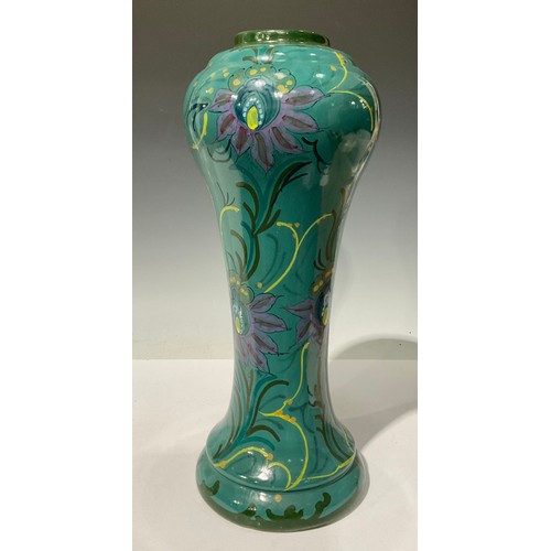 678 - A large Gouda Art Nouveau waisted vase and cover, decorated in polychrome with stylised flowers on a... 