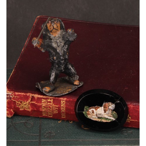 695 - An early 20th century painted metal model, Spaniel conductor, standing holding a musical baton, indi... 