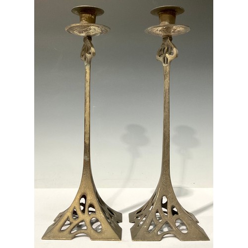 696 - A large pair of Art Nouveau style silvered cast metal candlesticks, spreading square base pierced in... 