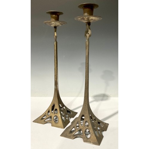 696 - A large pair of Art Nouveau style silvered cast metal candlesticks, spreading square base pierced in... 