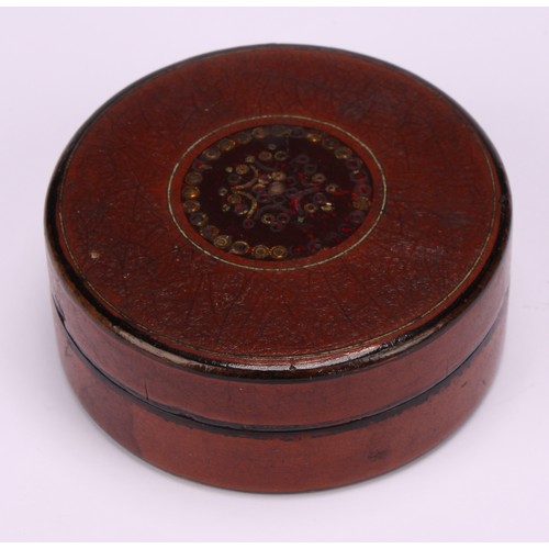 699 - An early 19th century vernis martin circular snuff box, the push-fitting cover decorated in gilt wit... 