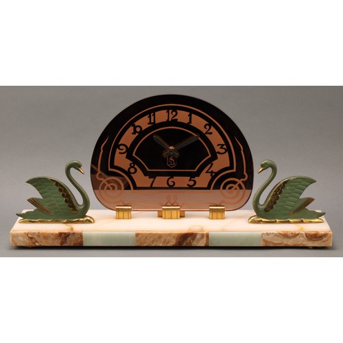 18 - An Art Deco period mantle clock, demi-lune brass face with Arabic scallop shaped chapter, flanked by... 