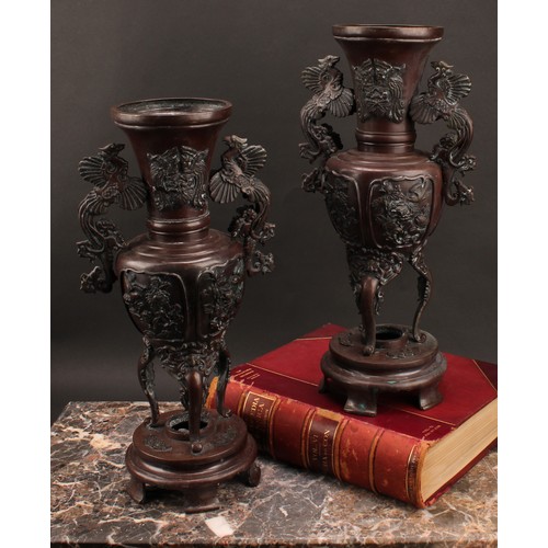 44 - A pair of large Japanese Meiji period patinated bronze shouldered vases on stands, the tapering neck... 