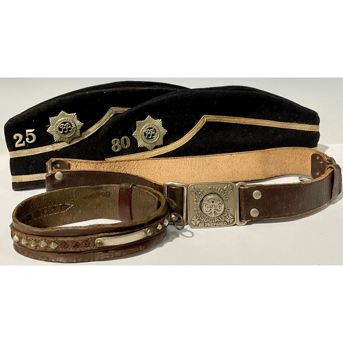 744 - A mid 20th century Boys Brigade side cap; another; a Girl Guides Association leather belt; a studded... 