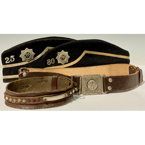 744 - A mid 20th century Boys Brigade side cap; another; a Girl Guides Association leather belt; a studded... 