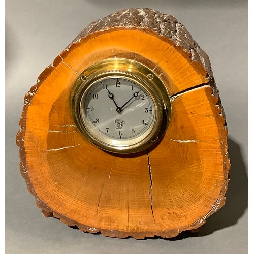 757 - A Smiths motorcar dashboard clock, serial number P-161580, mounted in a polished tree trunk section,... 