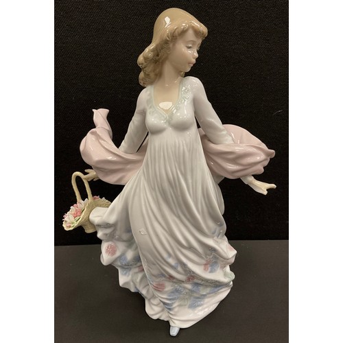 11 - Lladro, Spring Splendor, figure of a young woman holding a basket of flowers, 30 cm high.