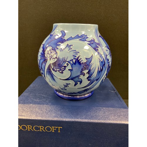 12 - A Moorcroft ‘Florian’ pattern ovoid vase, two tone blue decoration, second quality, 17cm high, boxed... 