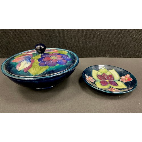 16 - An early 20th Century Moorcroft circular ‘Clematis’ pattern lidded bowl, 17cm dia; a pin dish, in th... 