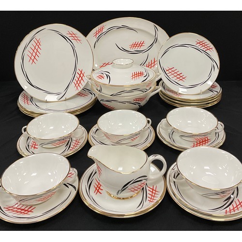 75 - A mid century Dakin dinner service for five, red and black cross hatch design including; five dinner... 