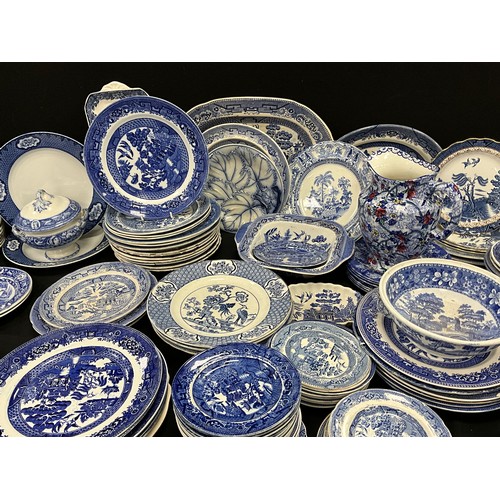 85 - A quantity of blue and white ware including; Booths Real Old Willow, Wedgwood, flow blue leaf plate;... 