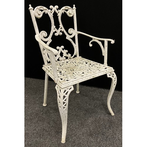 120 - Garden furniture - A cast iron table and set of four chairs, the table having a rounded-rectangular ... 