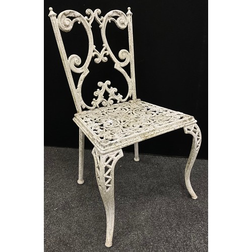 120 - Garden furniture - A cast iron table and set of four chairs, the table having a rounded-rectangular ... 