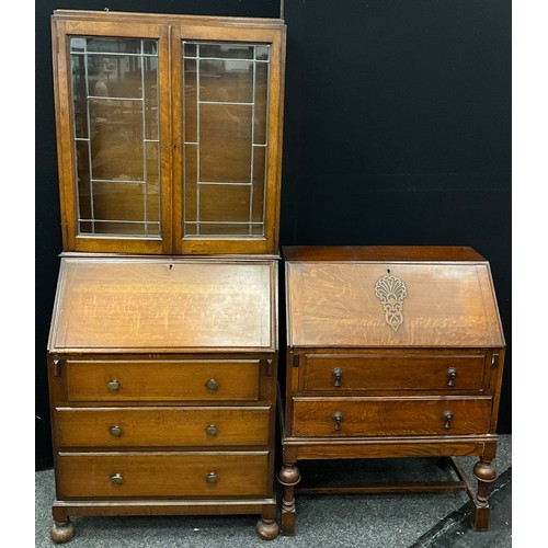 122 - A 1930’s oak bureau bookcase, 182cm high x 78cm wide x 41cm deep;  a similar oak bureau, (2).