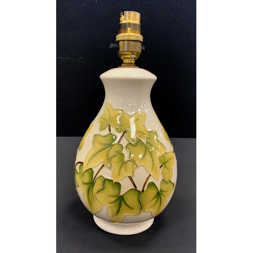 126 - Moorcroft lamp, decorated with tube lined foliage, 26cm high