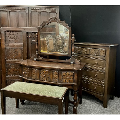 136 - A Titchmarsh and Goodwin style Gothic revival oak five piece bedroom suite, with carved floral roset... 