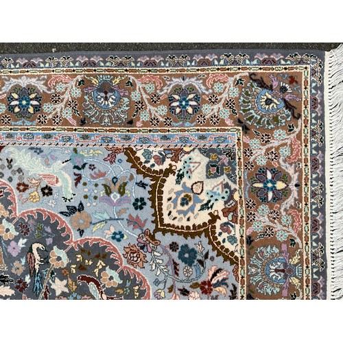 141 - An Indian Kashmir rug, knotted with a central lotus form medallion, within a field of stylised flora... 