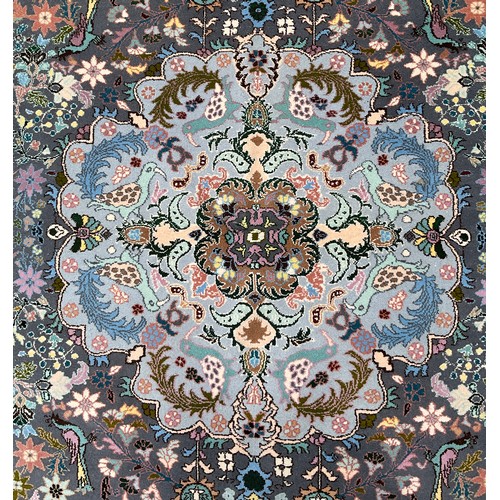 141 - An Indian Kashmir rug, knotted with a central lotus form medallion, within a field of stylised flora... 