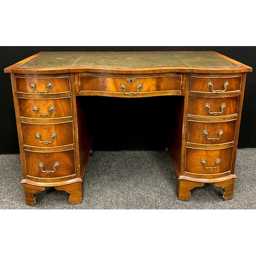 164 - A George III revival serpentine front mahogany pedestal desk, green leather writing surface, four gr... 