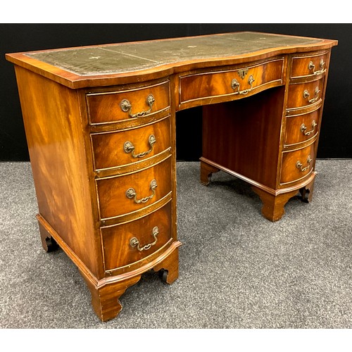 164 - A George III revival serpentine front mahogany pedestal desk, green leather writing surface, four gr... 