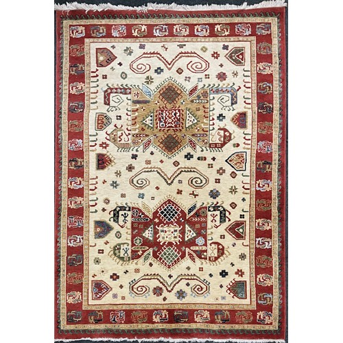 171 - A Kabir rug/carpet, two principle shaped medallions within cream field, rustet red cream and green m... 