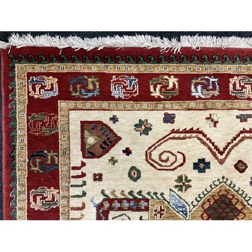 171 - A Kabir rug/carpet, two principle shaped medallions within cream field, rustet red cream and green m... 