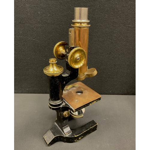 211 - A late 19th century monocular microscope by C. Reichert Wein No 12014, brass and black lacquered bod... 