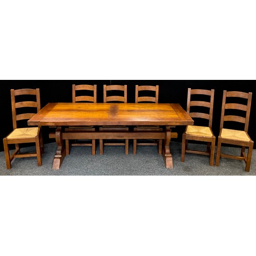 212 - An oak plank-top trestle dining table, 71.5cm high x 219.5cm long x 85cm wide, and a conforming set ... 