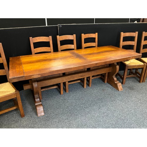 212 - An oak plank-top trestle dining table, 71.5cm high x 219.5cm long x 85cm wide, and a conforming set ... 